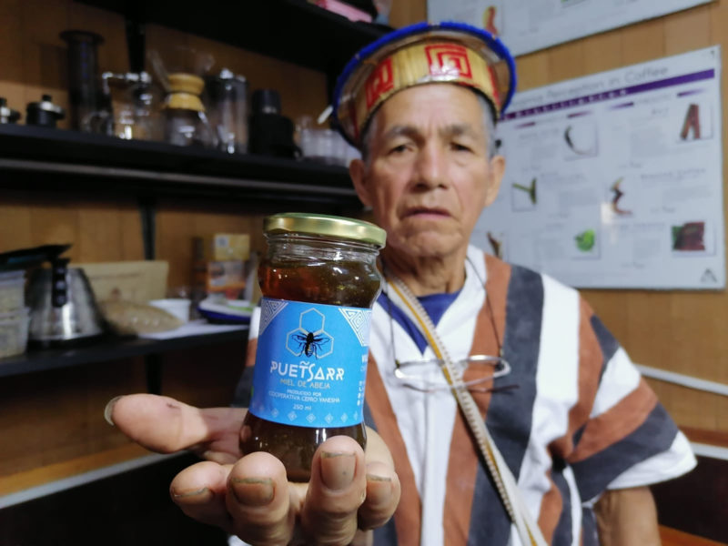 Man houdt pot honing uit Peru vast